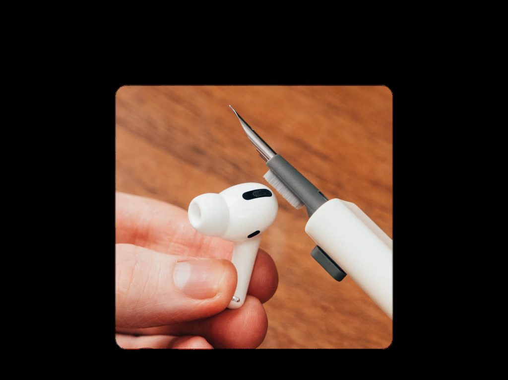 Cleaning Apple AirPods Pro earbud using DailyObjects Capsule Gadget Cleaning Kit with precision brush.