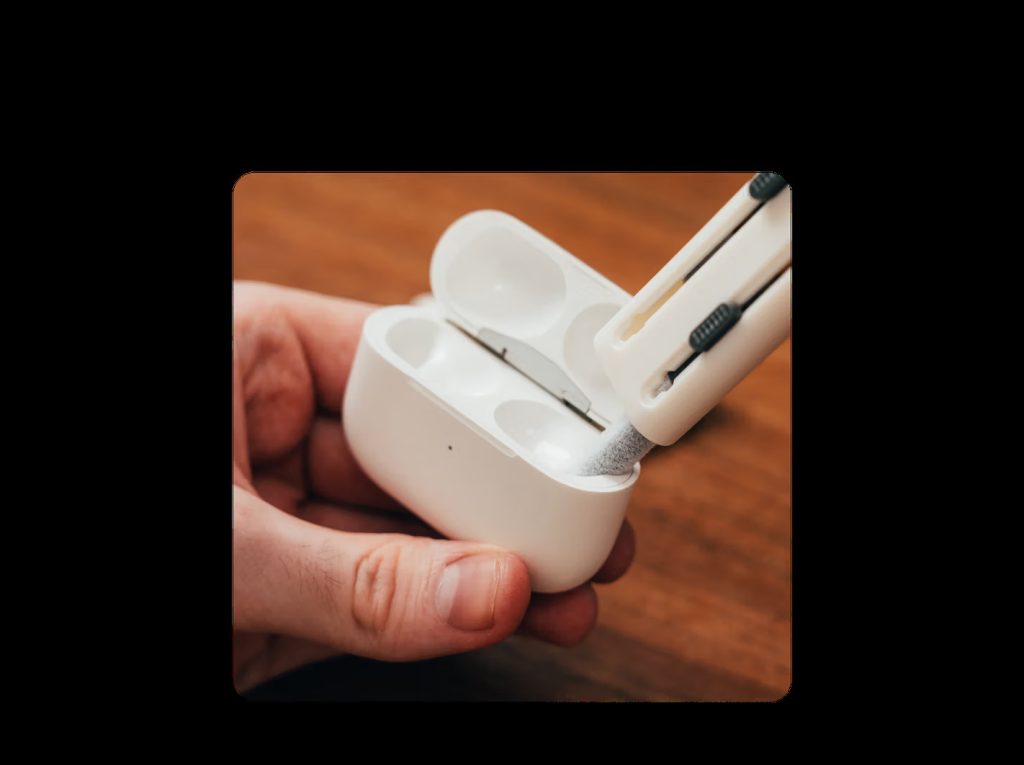 Cleaning the Apple AirPods charging case using a foam tool from DailyObjects Capsule Gadget Cleaning Kit.