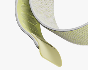 Close-up of a pastel yellow DailyObjects Track Nylon Apple Watch Band showing tabular velcro and breathable weave.