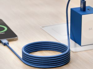 Blue Kevlar core 100W magnetic USB-C charging cable connected to phone and adapter on desk