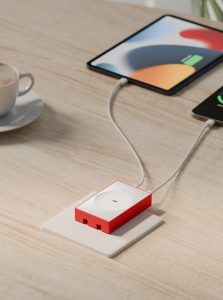 Red DailyObjects POP 45W twin port GaN5 adapter on a desk charging a tablet and smartphone via USB‑C cables