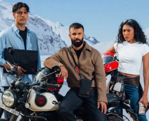 Three riders posing with Royal Enfield Hunter and Royal Enfield x DailyObjects tech accessories in a snowy landscape