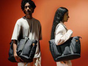 Idyll tote bag carrying daily essentials including a laptop and water bottle