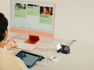 Minimal desk setup featuring the Loft Charging Station beside a monitor and accessories