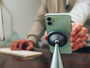 Wireless charger powering smartphone on desk setup for clutter free workspace and productivity